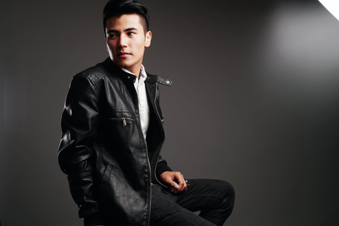 A person wearing a black leather jacket.