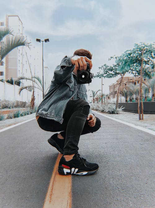: A person in streetwear with a camera